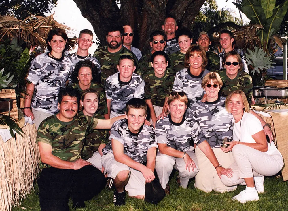Early Beets Catering team in matching camo shirts posing together for a group photo outdoors