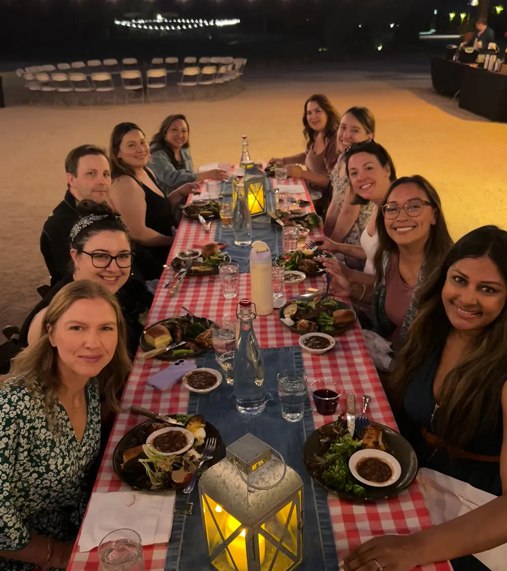 Beets team enjoying an outdoor dinner together at a long table