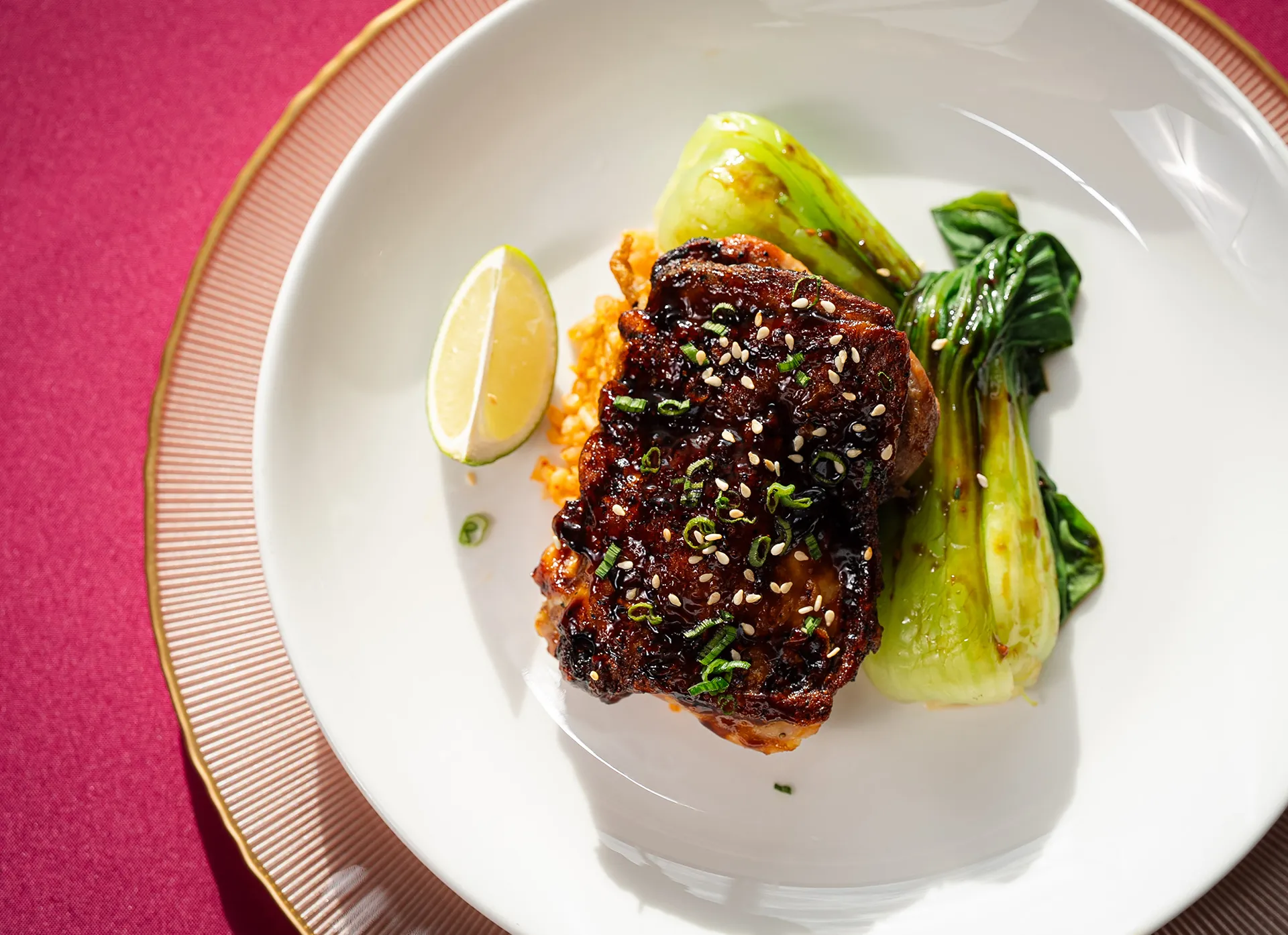 Sesame-glazed short rib with bok choy and a lime wedge